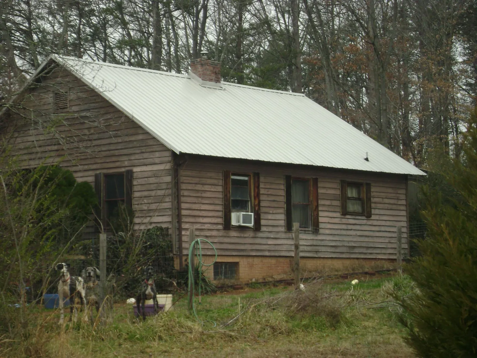 White metal roof on an old wood sided farmhouse, from a Metal Roof Installation job in Holy Cross